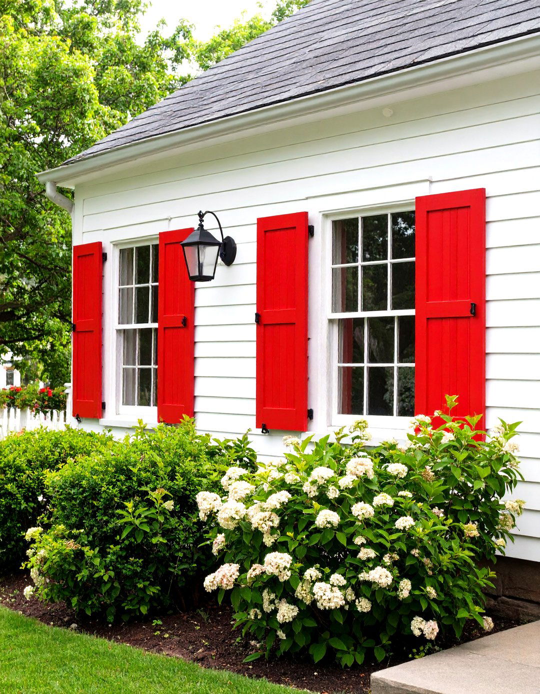 Dark Rustic Red Paint with Stone Accents - 20 red home exterior ideas