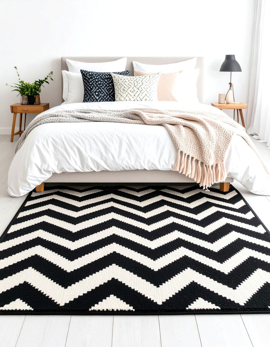 Geometric Black and White Rug Grounded by Pastel Throws - 20 Feminine Black and White Bedroom Ideas